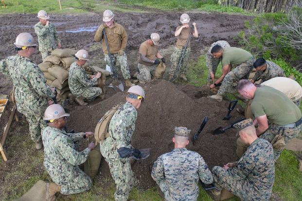 Seabees from Naval Mobile Construction Battalion 5 and Marines from I Marine Expeditionary Force fill sandbags during a military base construction and maintenance exercise during Pacific Blitz 2019  (U.S. Navy/Mass Communication Specialist 1st Class Aaron Bewkes)