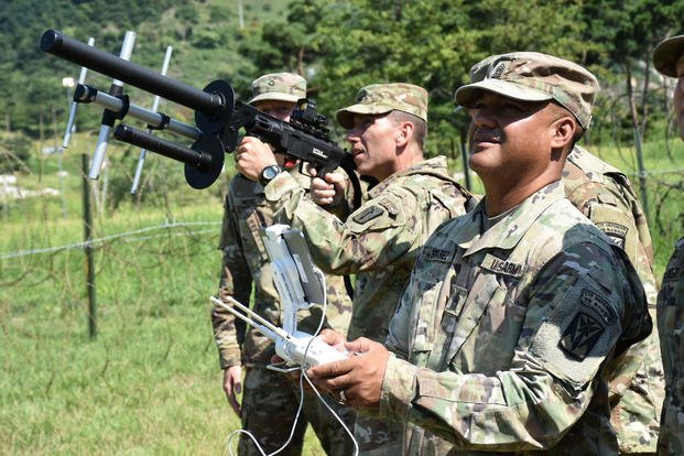 Col. Richard Wright prepares takes aim at an unmanned aerial system remotely controlled by as Command Sgt. Maj. Wilfredo Suarez, August 20, 2018, at Combined Task Force Defender. The 35th Air Defense Artillery Brigade command team received a hands-on briefing on E/6-52 AMD's counter-UAS capabilities. (U.S. Army photo/Marion Jo Nederhoed)