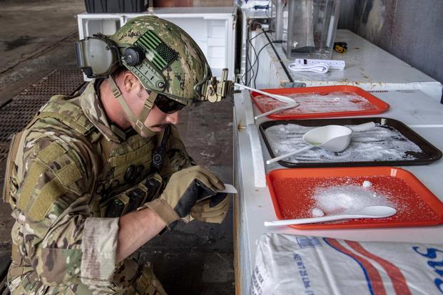 Explosive Ordnance Disposal Technician 3rd Class Marcus Crone prepares to collect a sample of a simulated unknown substance during an explosive test kit training demonstration (U.S. Navy/Mass Communication Specialist 2nd Class Kelsey L. Adams)