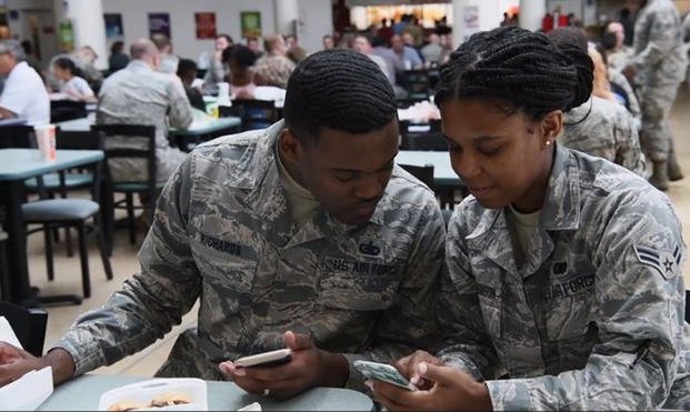 Airmen look at smartphones in a screengrab from a military PSA video about FaceApp (Screenshot via DVIDS)