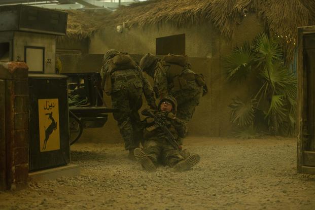 Members of 3rd Battalion, 8th Marine Regiment, rescue a simulated casualty during the Infantry Immersion Trainer at Camp Lejeune, N.C., on July 18, 2019. The IIT is an urban training area with various complexes that provide realistic and situational training to the various infantry units stationed at Camp Lejeune. (U.S. Marine Corps Photo by Cpl. Caleb T. Maher)