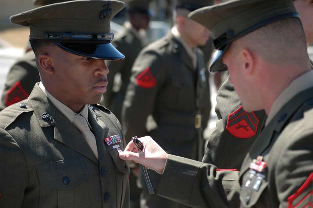 Staff Sgt. Dale Wojtowicz inspects a Headquarters and Headquarters Squadron Marine in his service alpha uniform during a uniform inspection at the Marine Corps Air Station in Yuma, Ariz., on March 24, 2009. The inspection was held to prepare the Marines for an official command inspection the following week. (U.S. Marine Corps photo by Lance Cpl. Austin Hazard)