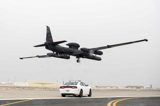 A 99th Expeditionary Reconnaissance Squadron U-2 Dragon Lady pilot drives a high-performance chase car on the runway to catch a U-2 performing a low-flight touch and go at Al Dhafra Air Base, United Arab Emirates, on March 15, 2019. While driving the chase cars, U-2 pilots aid the pilot flying the U-2 by radioing altitude and runway alignments during take-offs and landings. (U.S. Air Force photo by Senior Airman Gracie I. Lee)