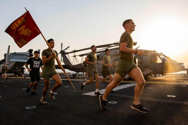 Sailors and Marines aboard amphibious assault ship USS Boxer run during a Labor Day 5K.