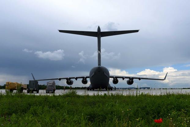 A C-17 Globemaster III from the 60th Air Mobility Wing is parked near the flightline at the Henri Coanda International Airport May 25, 2019, in Bucharest, Romania.  (U.S. Air Force/ 2nd Lt. Richard Longoria)