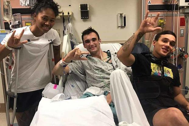 Sgt. Aechere Crump and Pfc. Victor Alamo visit with Spc. Ezra Maes (center) during their recovery at Brooke Army Medical Center at Joint Base San Antonio-Fort Sam Houston, Texas. Crump and Alamo survived the tank accident with Maes in early 2018. (Courtesy photo via DVIDS)