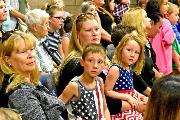  An Army reserve military spouse sits at a farewell ceremony in Montana. 