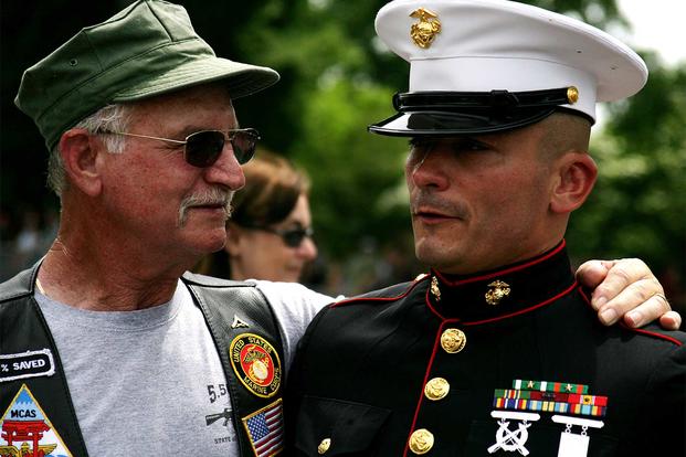 A Marine Vietnam veteran embraces Staff Sgt. Tim Chambers to thank him for his support of all veterans, May 25, 2009. (U.S. Marine Corps/Cpl. Scott Schmidt)