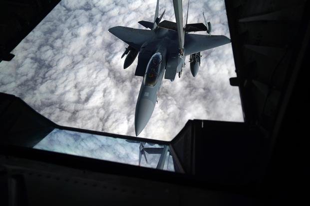 A KC-10 Extender from the 908th Expeditionary Air Refueling Squadron, Al Dhafra Air Base, United Arab Emirates, refuels a F-15E Strike Eagle