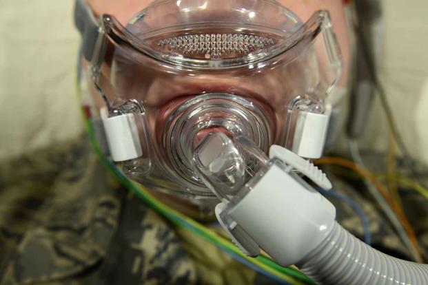 An Airman wears a continuous positive-air pressure mask in the 673d Medical Group Sleep Disorder Clinic at the Joint Base Elmendorf-Richardson Hospital, Alaska, Oct. 30, 2015. (U.S. Air Force/Airman 1st Class Christopher R. Morales)