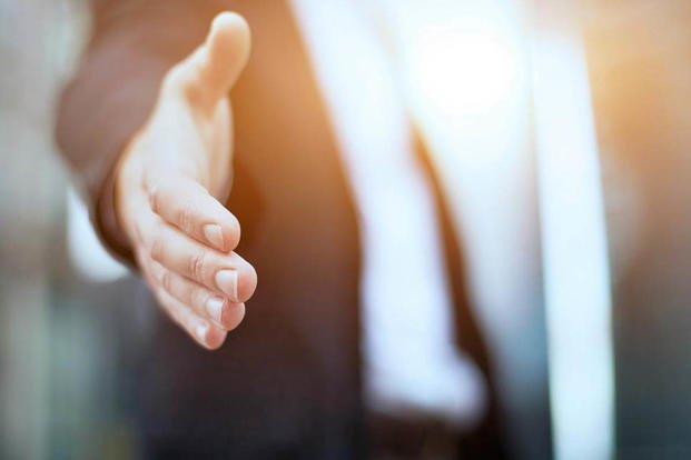 stock photo of a man reaching for a handshake