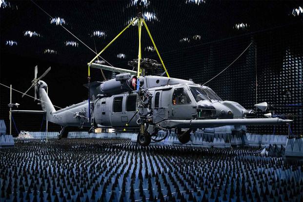 A 413th Flight Test Squadron HH-60W hangs in the anechoic chamber.