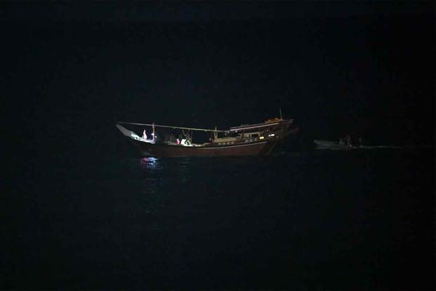 The guided-missile cruiser USS Normandy (CG 60) boards a stateless dhow.