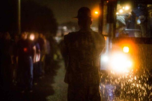 A drill instructor orders new recruits to get off the bus at Parris Island.
