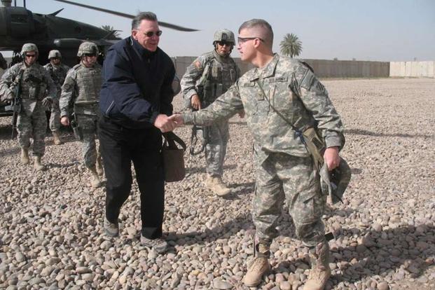 Retired Gen. Jack Keane shakes hands with Col. Wayne W. Grigsby, Jr., at Combat Outpost Carver, Iraq.