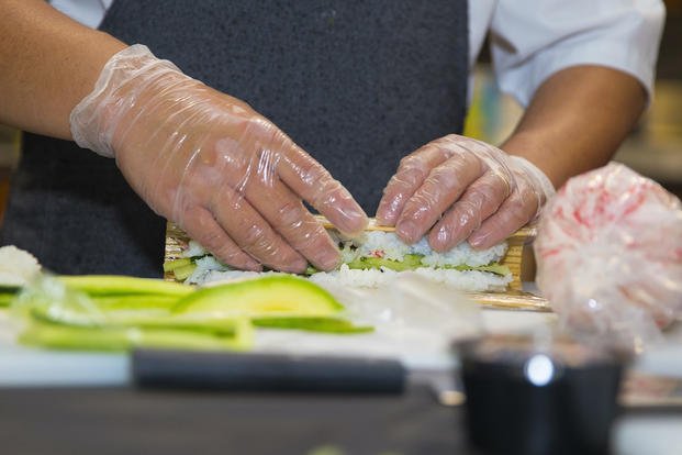 close up of rolling sushi