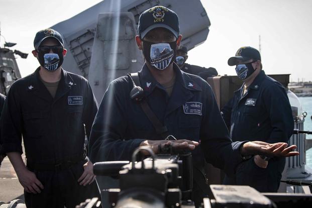 A sailor conducts .50 caliber machine gun training on the missile deck of the Freedom-class LCS USS Detroit.