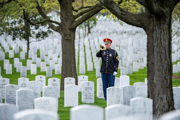 A bugler from the U.S. Army Band plays Taps at Arlington National Cemetery.