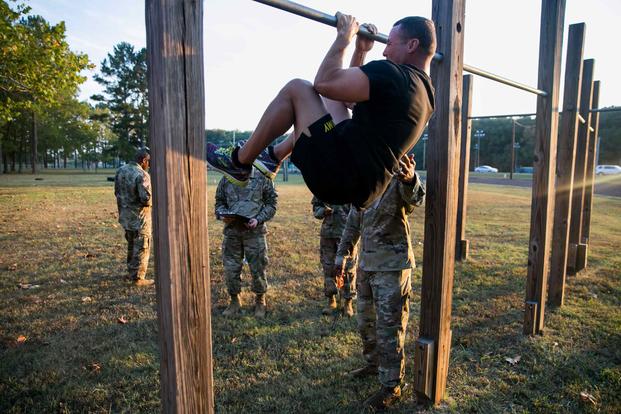 Maj. Bart Brimhall, the deputy Product Manager for Missile Field Development, executes a leg tuck for the Army Combat Fitness Test.