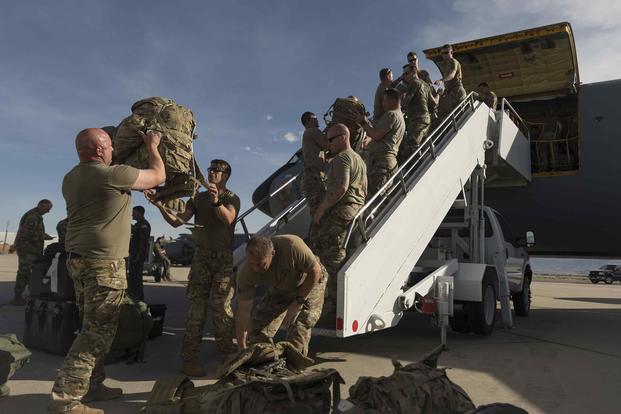 Soldiers from the Utah National Guard load bags onto a KC-135R aircraft at Roland R. Wright Air National Guard Base.