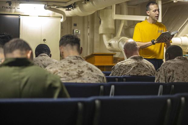 A Navy chaplain assigned to the USS New York reads scripture.