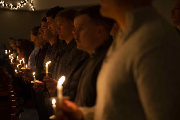 U.S. troops and their families attend a candlelight vigil aboard Marine Corps Air Station Iwakuni.