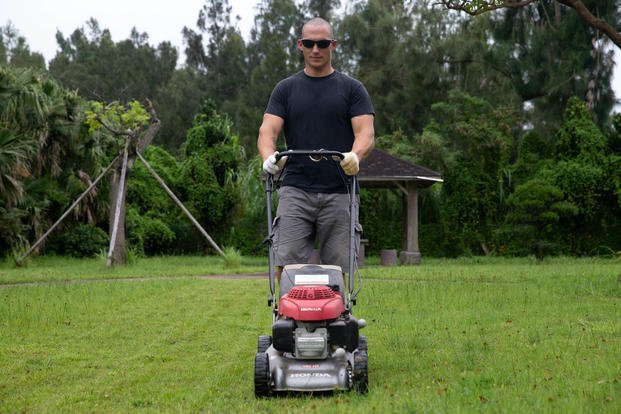 man pushing lawn mower