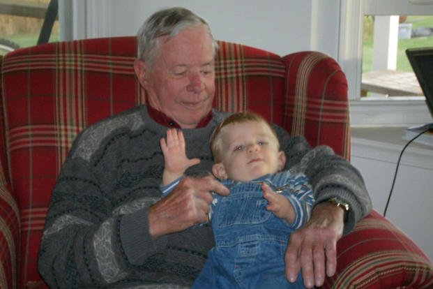 a grandfather holding his grandson