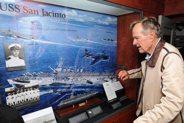 ATLANTIC OCEAN - JULY 14: In this handout image provided by the U.S. Navy, former President George H.W. Bush looks at a display of his former ship, the aircraft carrier USS San Jacinto (CVL 30), in the tribute room of the aircraft carrier that bears his name, USS George H.W. Bush (CVN 77) July 14, 2010 in the Atlantic Ocean. Bush and former first lady Barbara Bush spent their time onboard watching flight operations, touring the ship and visiting with the crew. The George H.W. Bush is conducting training in 