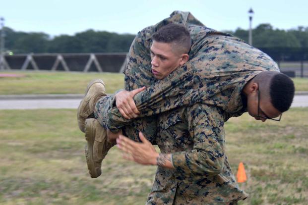 A Marine carries another Marine during a Combat Fitness Test.