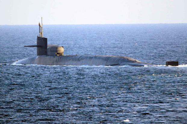 The guided-missile submarine USS Georgia transits the Strait of Hormuz.