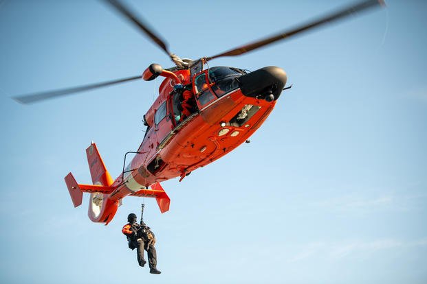 Coast Guard canine Kyra and Petty Officer 1st Class Clinton Stone MH-65 Dolphin Helicopter