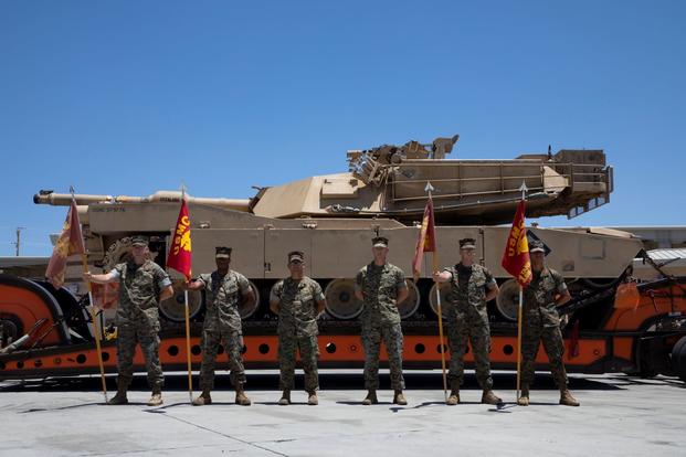 Marines pose for a photograph in front of the last tank assigned to 1st Tank Battalion.