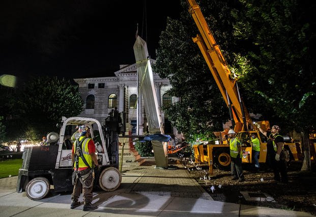 Workers remove a Confederate monument in Decatur, Ga.