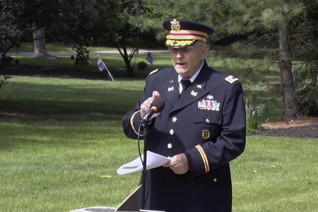 retired Army Lt. Col. Barnard Kemter taps the microphone