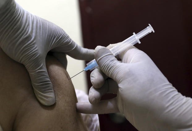 A man receives a shot of COVID-19 vaccine in Afghanistan.