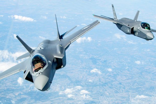 Two F-35 Lightning II’s bank after receiving fuel over the Midwest