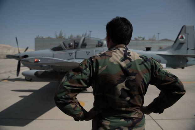 Afghan A-29 Super Tucano crew chief stands ready to assist