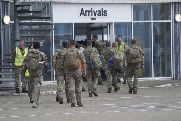 British armed forces 16 Air Assault Brigade members walk to the air terminal at RAF Brize Norton.