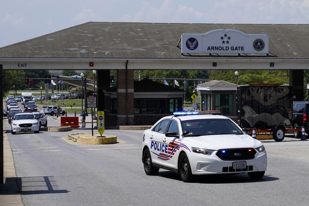 A Metropolitan Police Department cruiser drives out of an entrance to Joint Base Anacostia-Bolling.