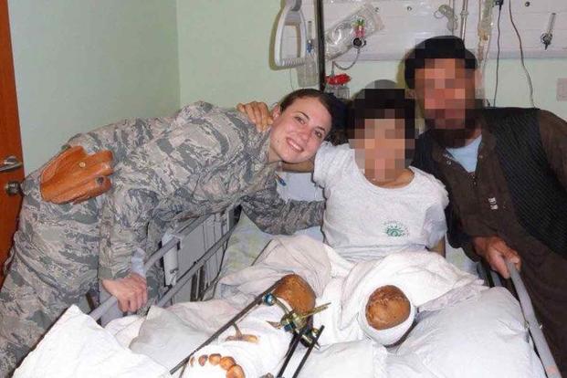 Jen Burch with a boy who had lost his leg after being hit with an IED.