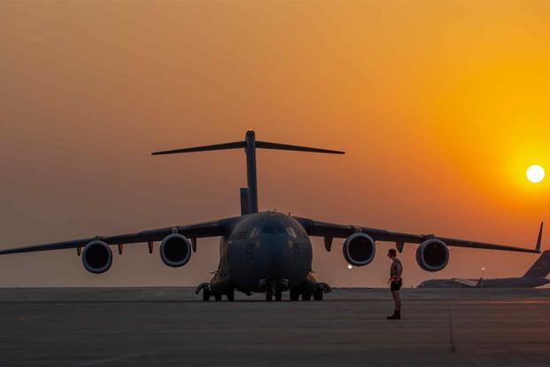 C-17 Globemaster lll as another C-17 taxis at Al Udeid Air Base, Qatar. 