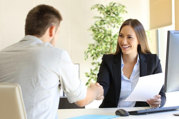 woman interviewing man for job