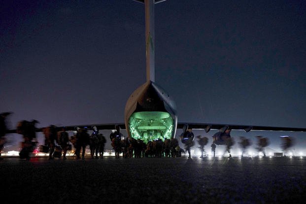 Soldiers prepare to board a U.S. Air Force C-17 Globemaster III aircraft at Hamid Karzai International Airport in Kabul, Afghanistan.