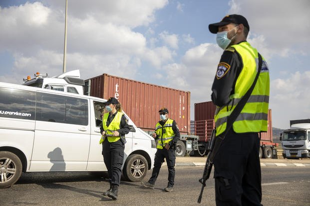 Israeli police check cars with Palestinian laborers, searching for escapees