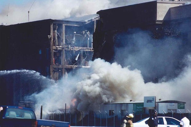 Fire crews work to put out the flames following the collapse of the E Ring, 11 September 2001.
