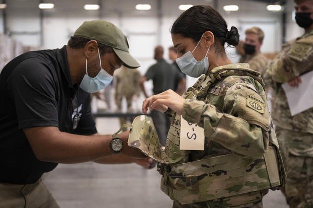 A soldier gets fitted for a modular scalable vest (MSV).