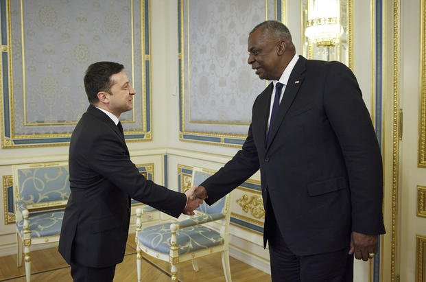 Ukrainian President Volodymyr Zelenskyy shakes hands with U.S. Defense Secretary Lloyd Austin 