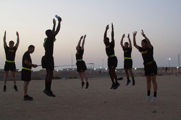 Soldiers do the high jumper before their physical readiness training assessment.