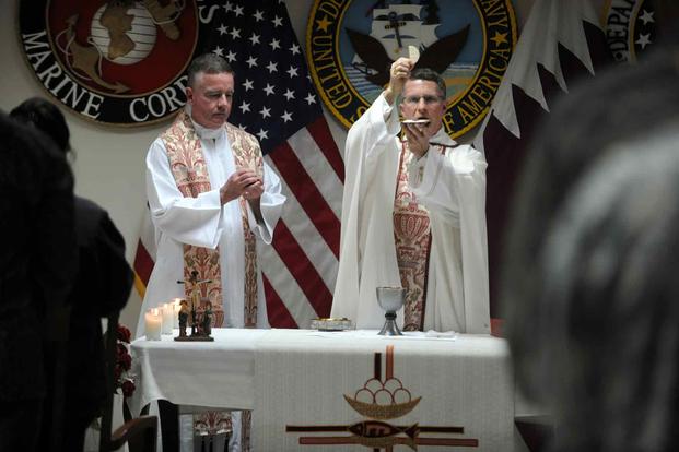 Archbishop Timothy P. Broglio holds the Holy Eucharest before Communion